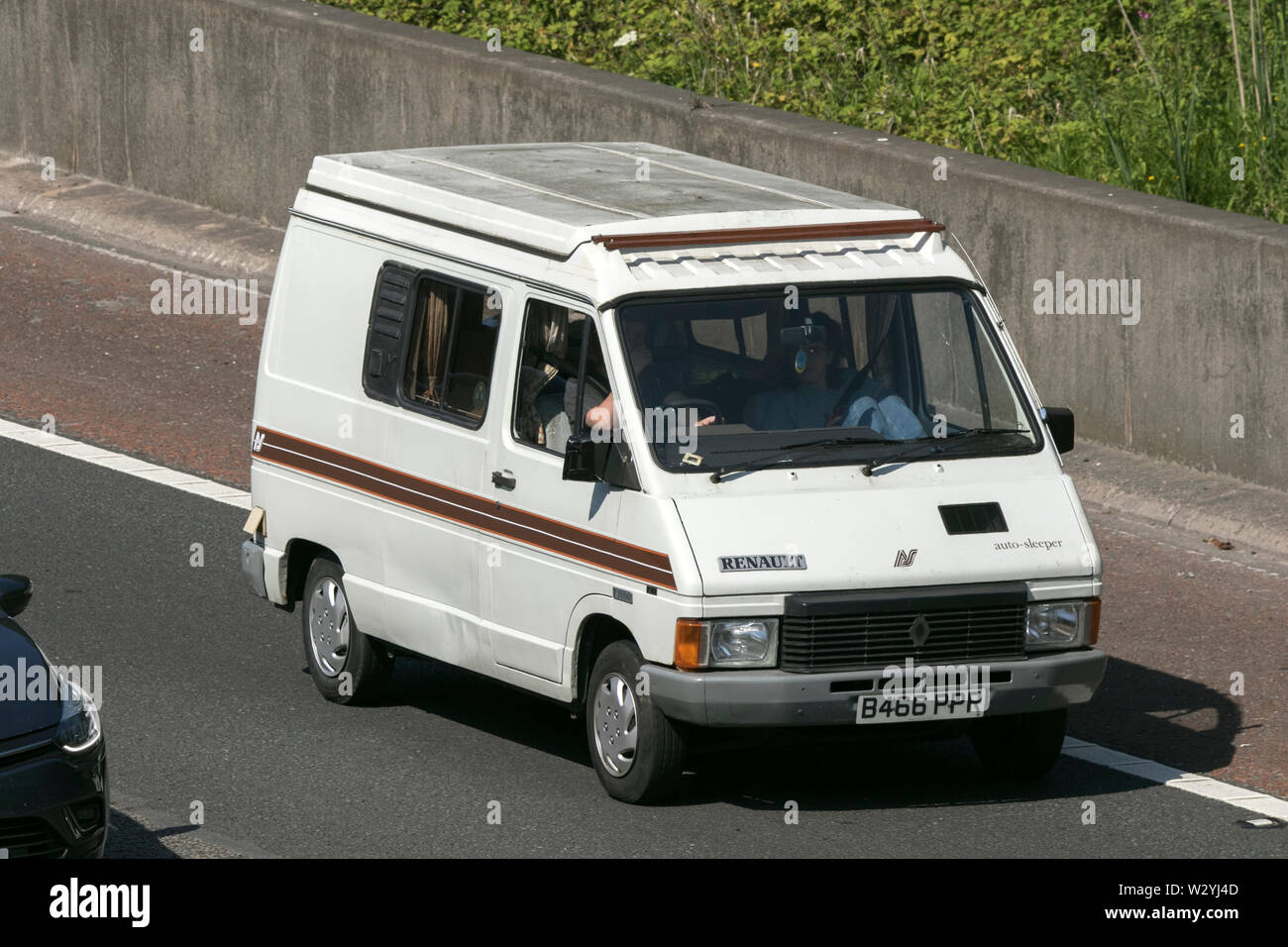 1984 Renault Trafic AS Camper; Vintage classic restored vehicles cars traveling on the M6 motorway to Leighton Hall car show in Carnforth, Lancaster Stock Photo