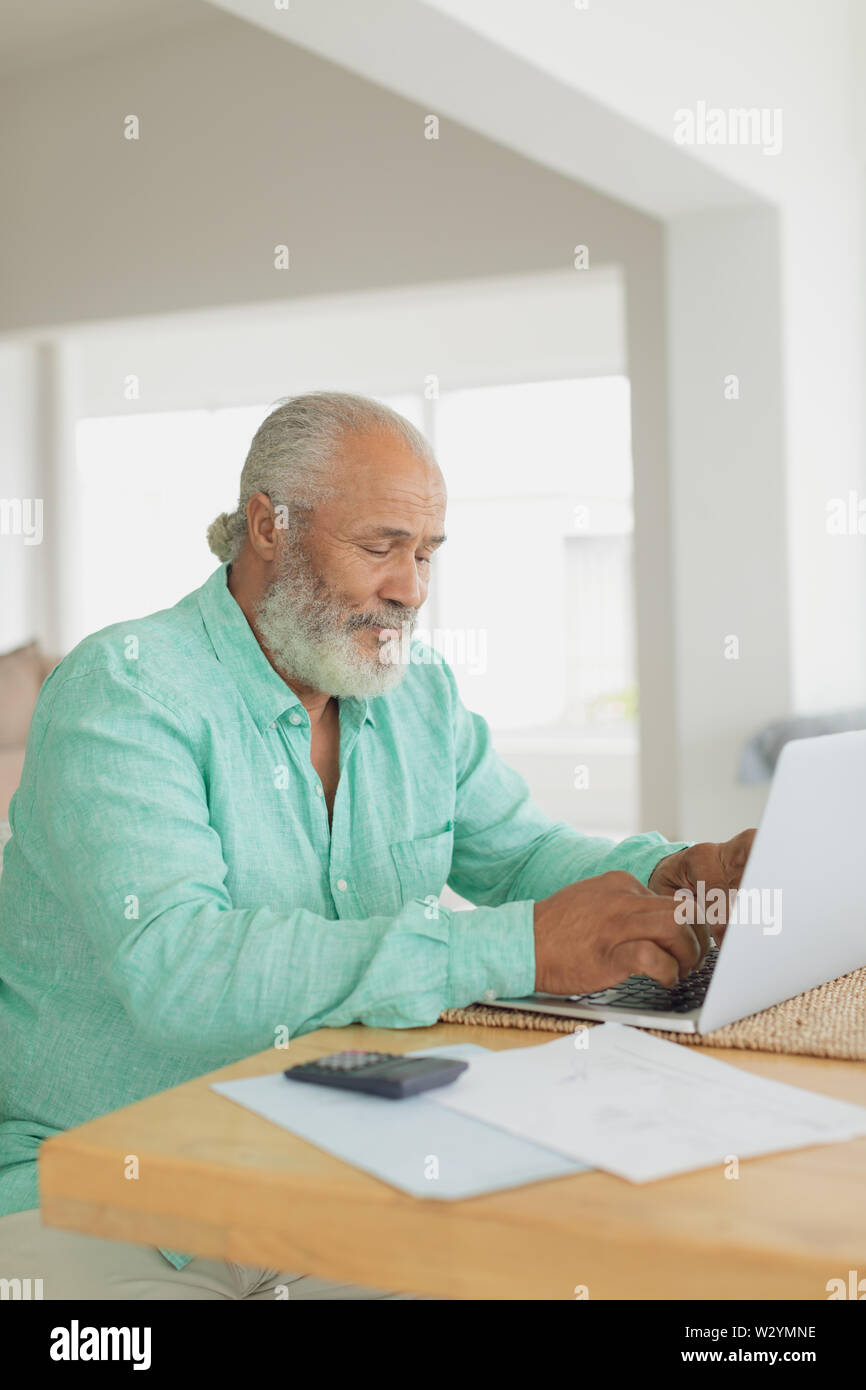 Man using laptop on table Stock Photo
