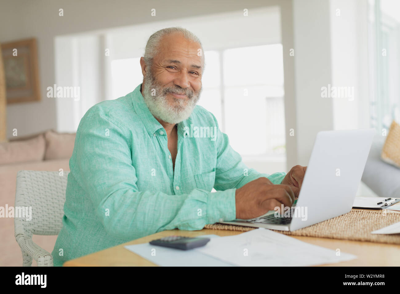 Man using laptop on a table Stock Photo