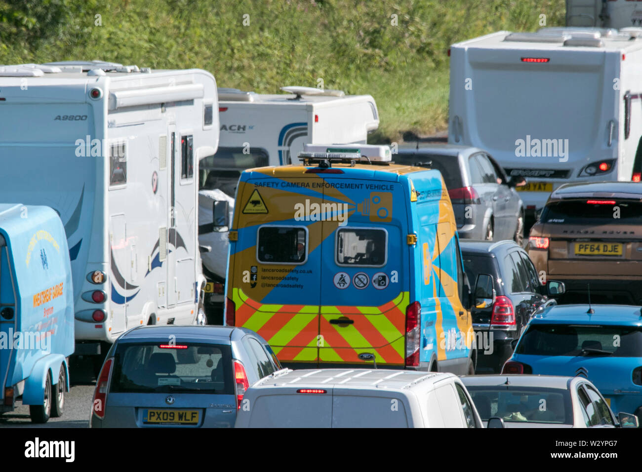A Lancashire police speed enforcement camera van traveling in heavy traffic jam on the M6 motorway near Lancaster Stock Photo