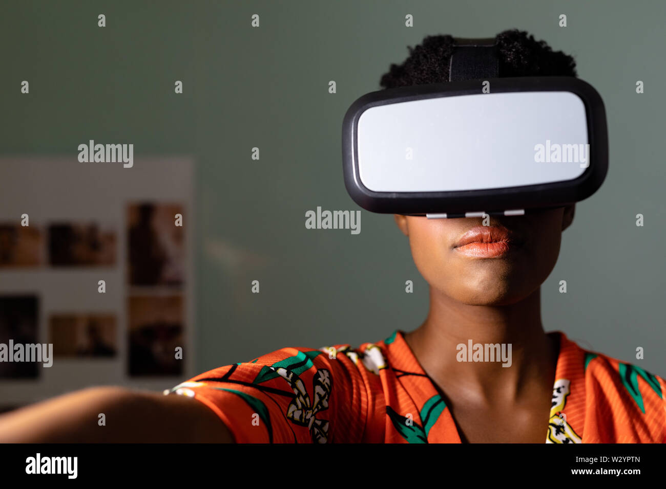 Female graphic designer using virtual reality headset in office Stock Photo