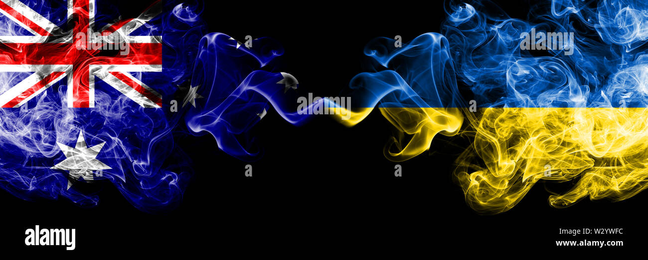 Australia vs Ukraine, Ukrainian smoky mystic flags placed side by side. Thick colored silky smokes combination of national flags of Australia and Ukra Stock Photo