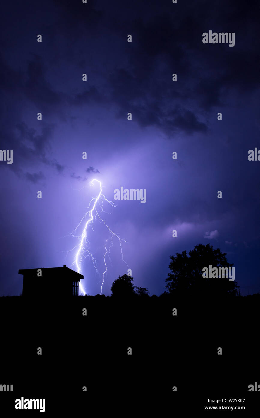 Lightning flashes over the night sky during thunderstorm Stock Photo ...