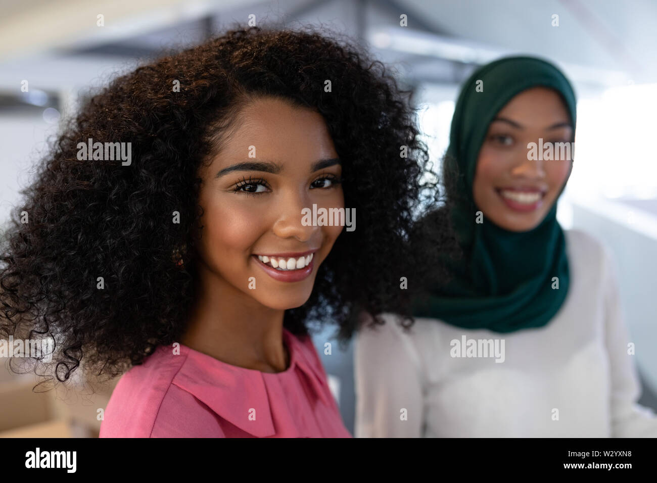 Female executives smiling in office Stock Photo