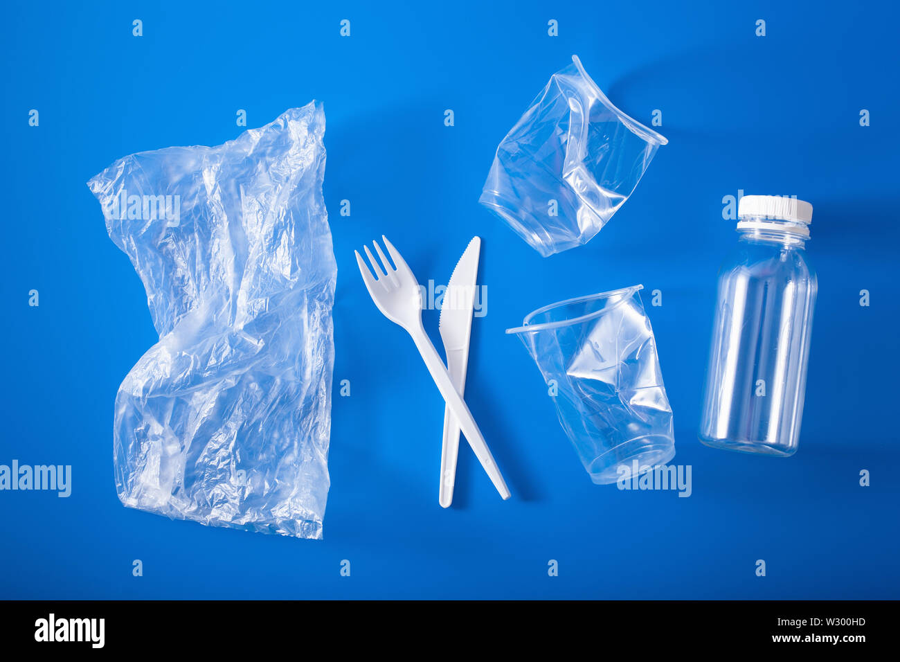 single use plastic cups, forks, spoons. concept of recycling plastic