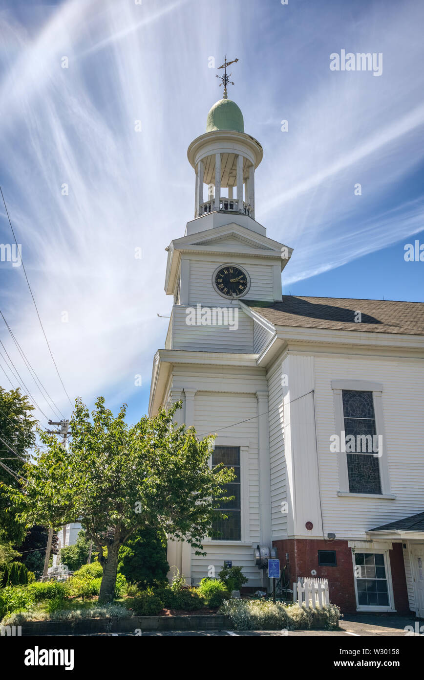 Wellfleet, MA - June 12, 2019: The First Congregational Church holds the 'Town Clock' in it's bell tower and is the only one in the world that still c Stock Photo