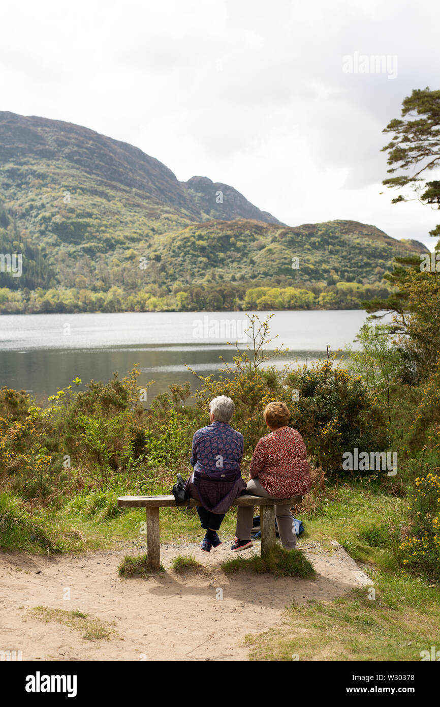 A couple look over a lake in Killarney National Park, County Kerry, Ireland. Stock Photo