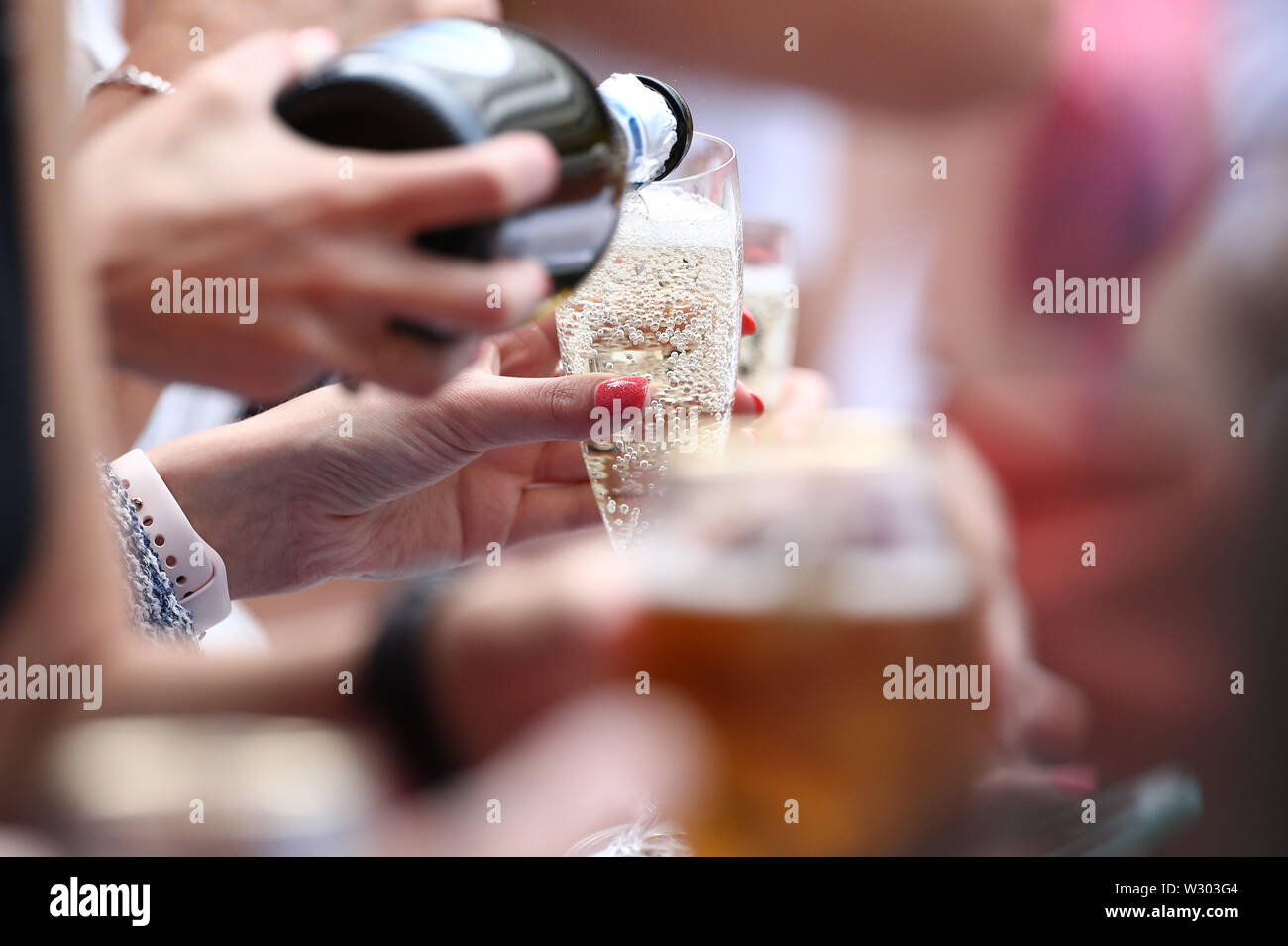Wimbledon Uk 11th July 2019 The All England Lawn Tennis And Croquet Club Wimbledon England Wimbledon Tennis Tournament Day 10 A Woman Pours Champagne During The Ladies Semi Final Singles Match Between