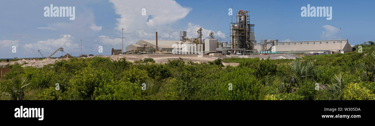 Mining, managing & transporting of titanium mineral sands. To separation and process plants & warehouse. Stock piles on left & coast and ocean behind. Stock Photo