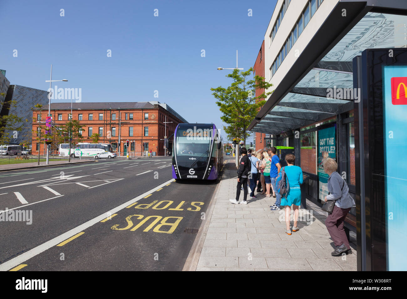 Ireland, North, Belfast, Titanic Quarter, Tourists awaiting Glider rapid transit bus Stock Photo