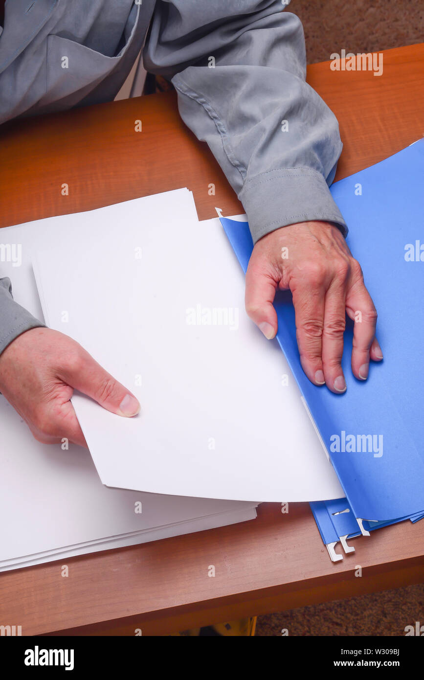 File folders are being used to organize paperwork needed for office or home use . Stock Photo