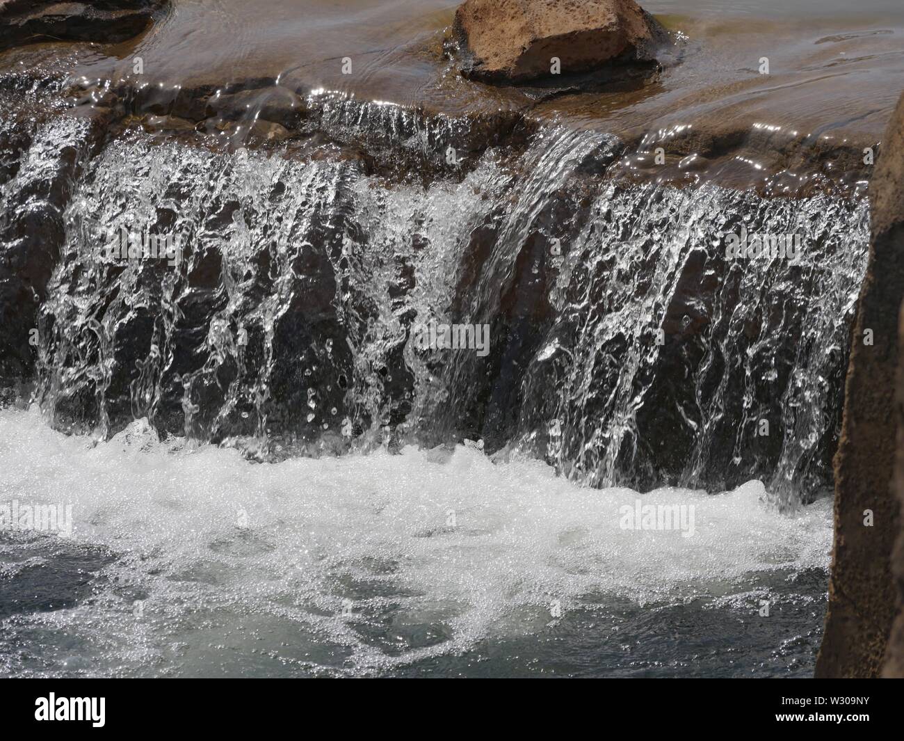 Close up water cascading from a small waterfalls in a river Stock Photo ...