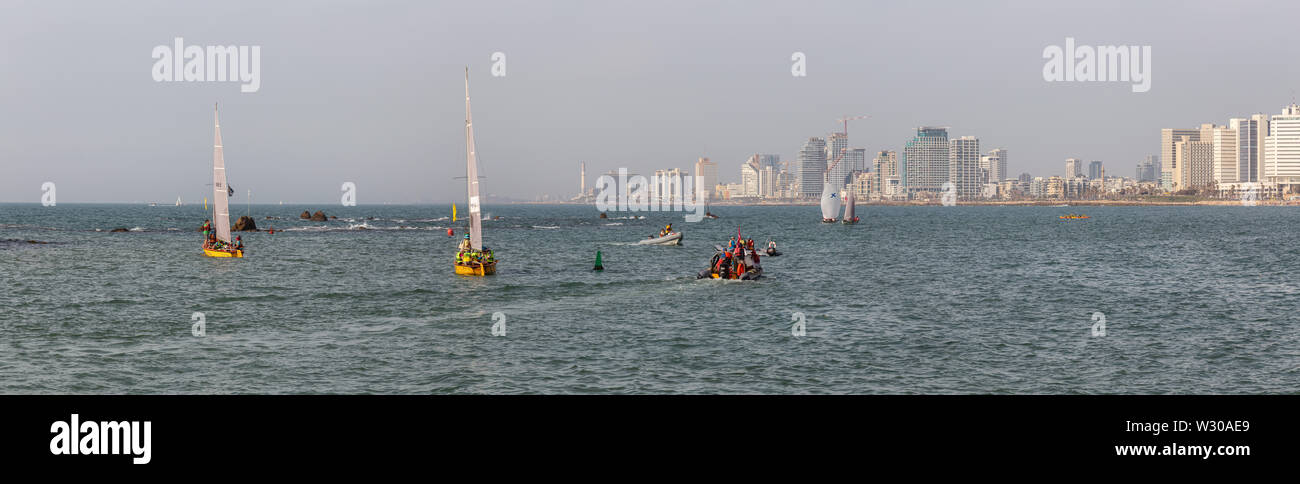 Tel Aviv, Israel - April 13, 2019: Panoramic view of Sail Boats in the ocean near the Old Port of Jaffa during a sunny day. Stock Photo