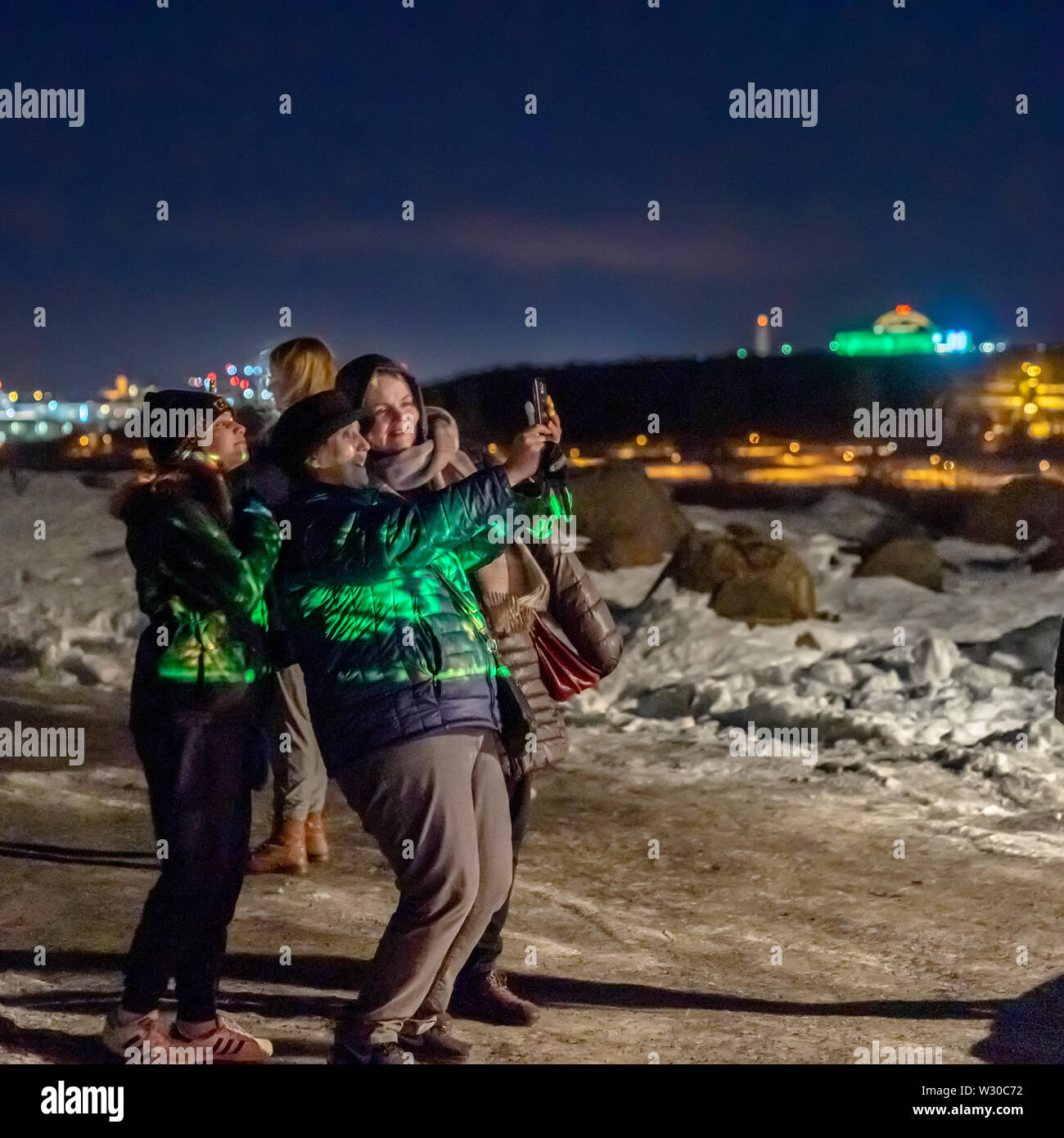 People taking pictures during the Winter lights Festival, Reykjavik, Iceland Stock Photo