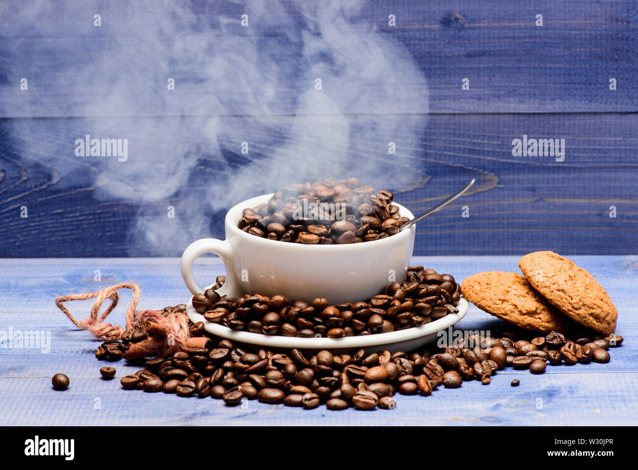 Degree Of Roasting Grain Cup Full Coffee Brown Roasted Beans White Clouds Of Smoke Blue Wooden Background Cafe Drinks Menu Fresh Roasted Coffee Beans Coffee For Inspiration And Energy Charge Stock Photo