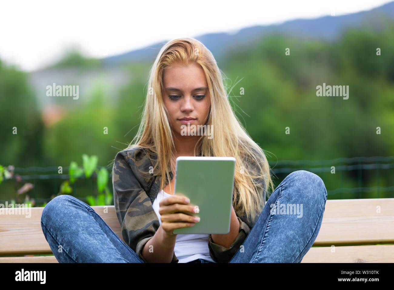 Teen girl sitting knees up hi-res stock photography and images - Alamy