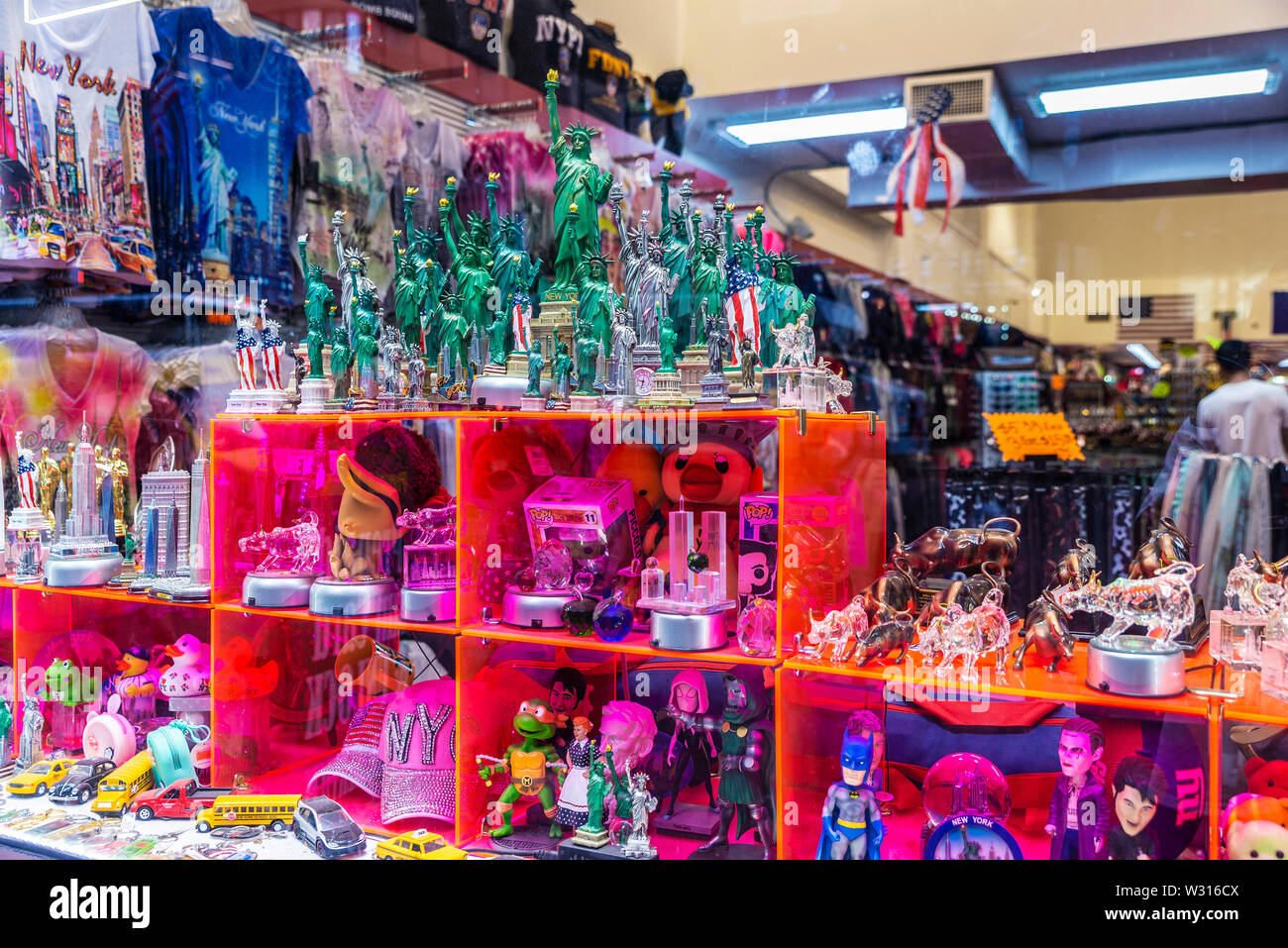 New York City, USA - August 1, 2018: Display of a gift and souvenir store with miniatures of the Statue of Liberty and the Wall Street Bull in Manhatt Stock Photo
