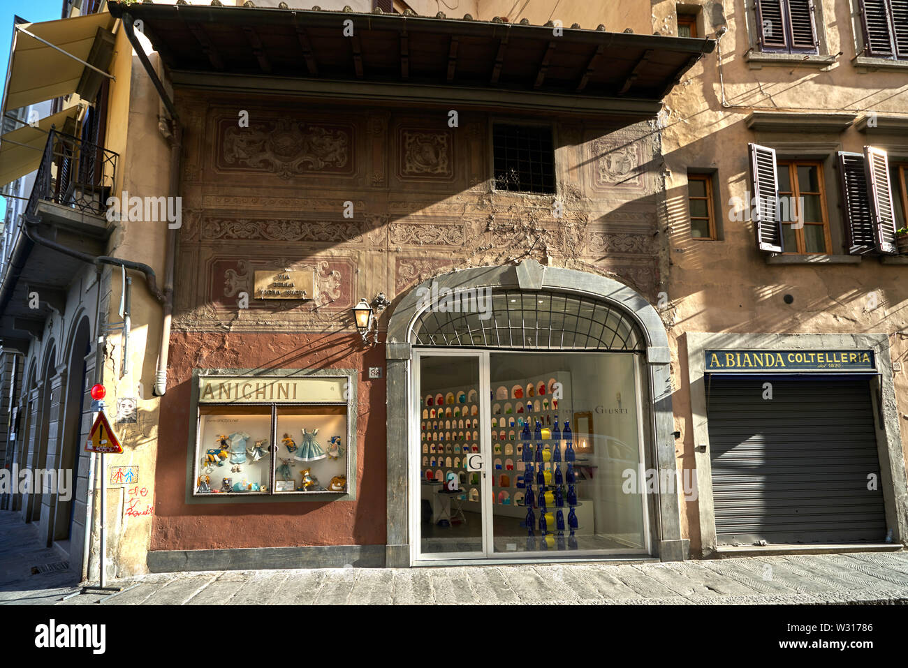 Shopfront with beautiful old fresco on walls in Florence (Firenze) Italy Stock Photo