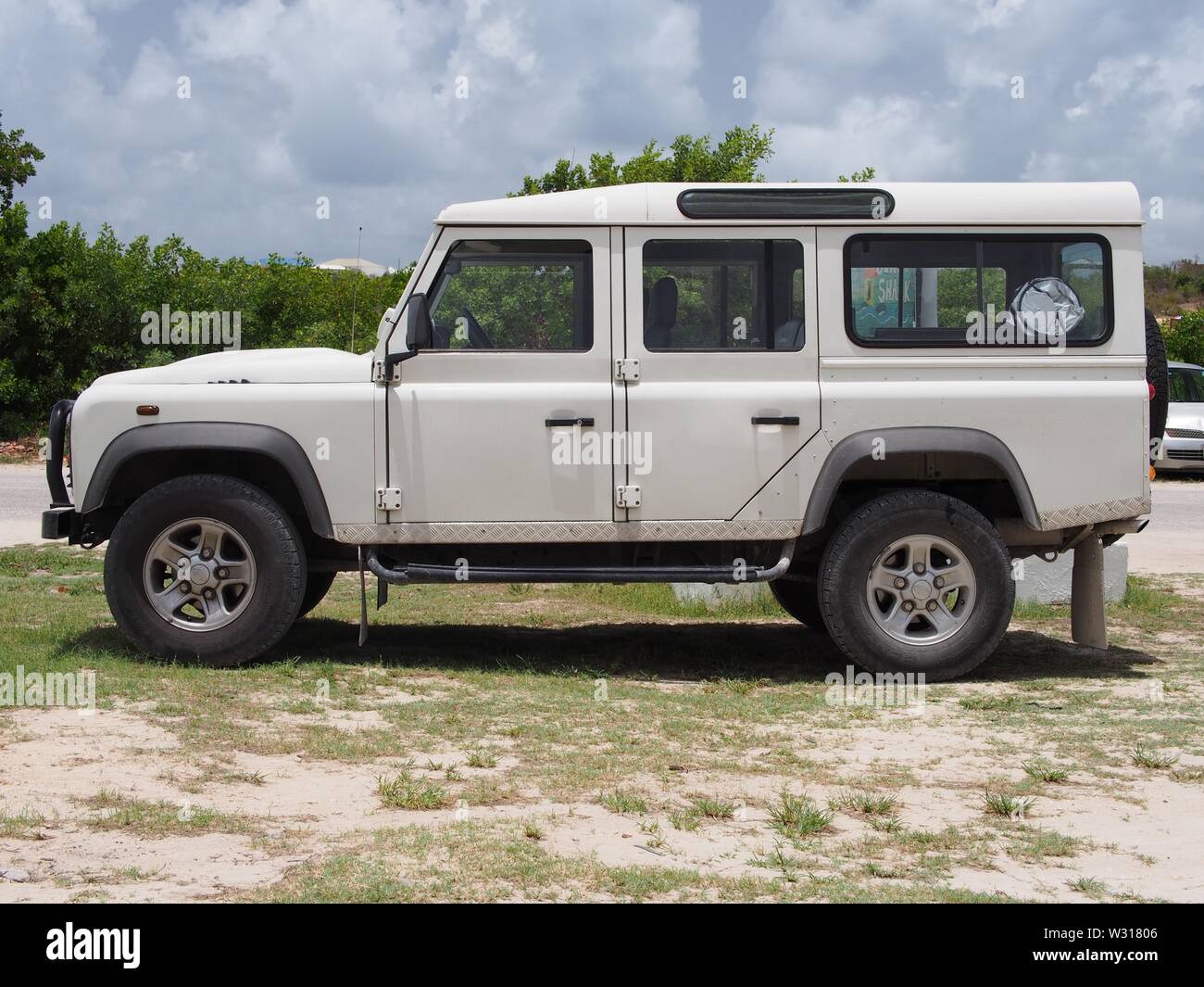 Side View Of A White Land Rover Defender 110 Anguilla Bwi Stock