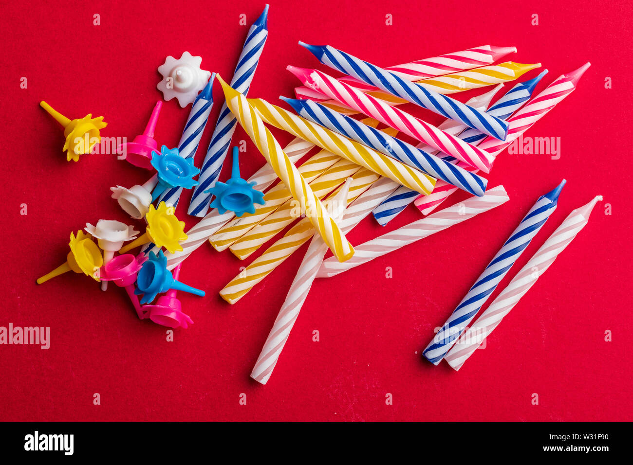 Group of birthday candles on red background. For birthday greeting card