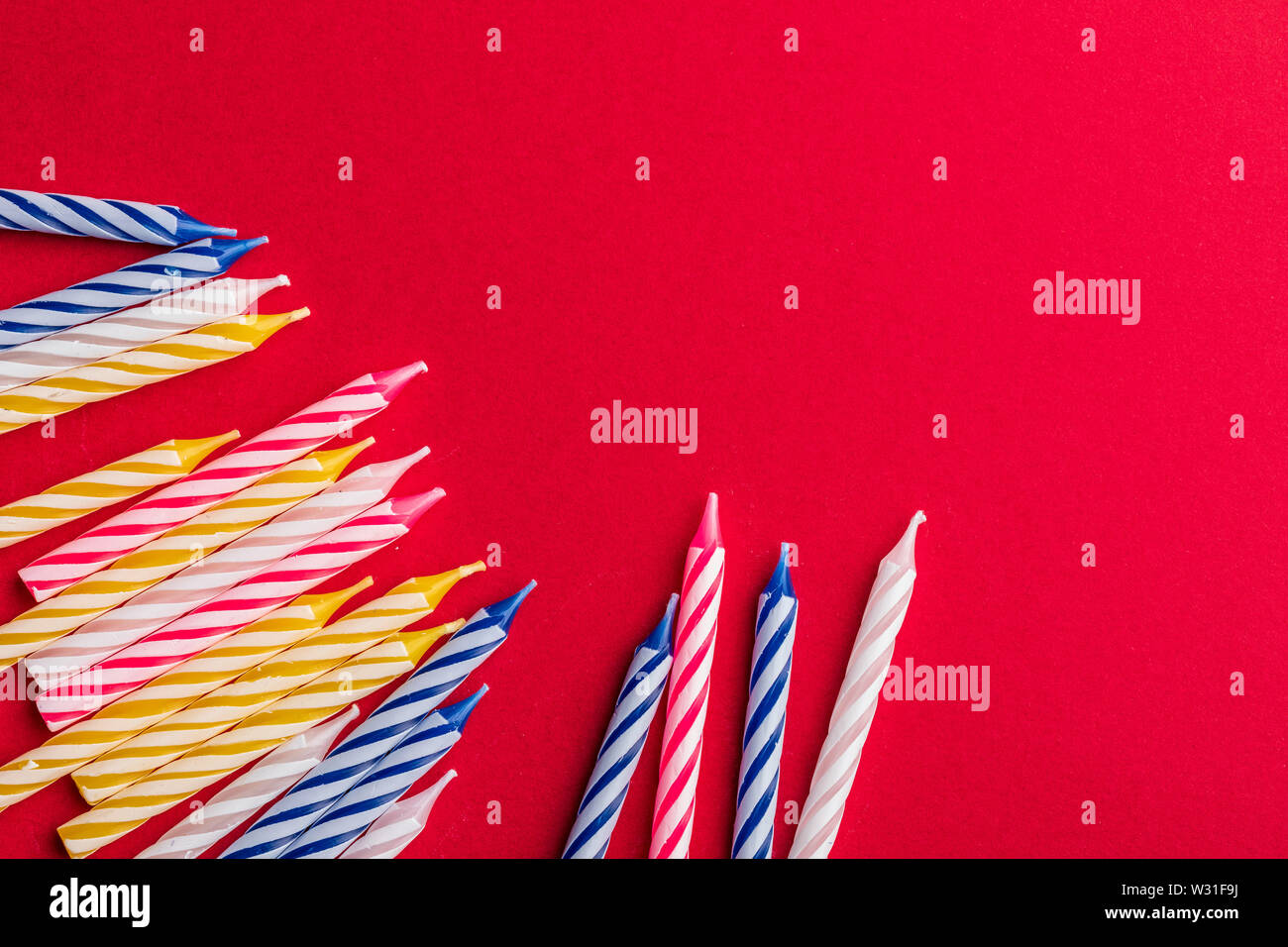 Group of birthday candles on red background. For birthday greeting card ...