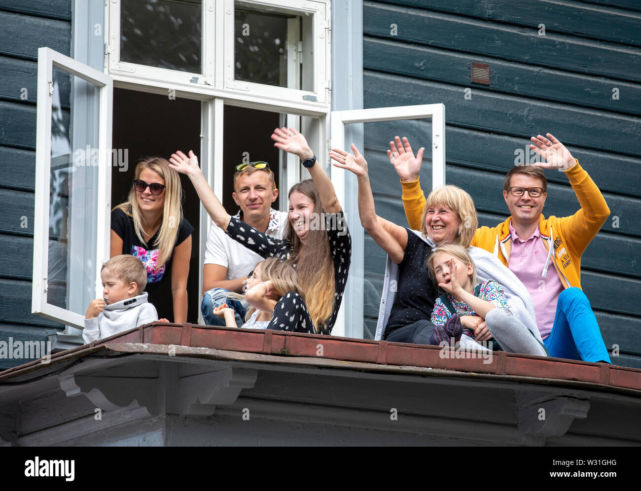 Tallinn, Estonia, 6th July, 2019: people greeting the song festival parade on the rooftops Stock Photo