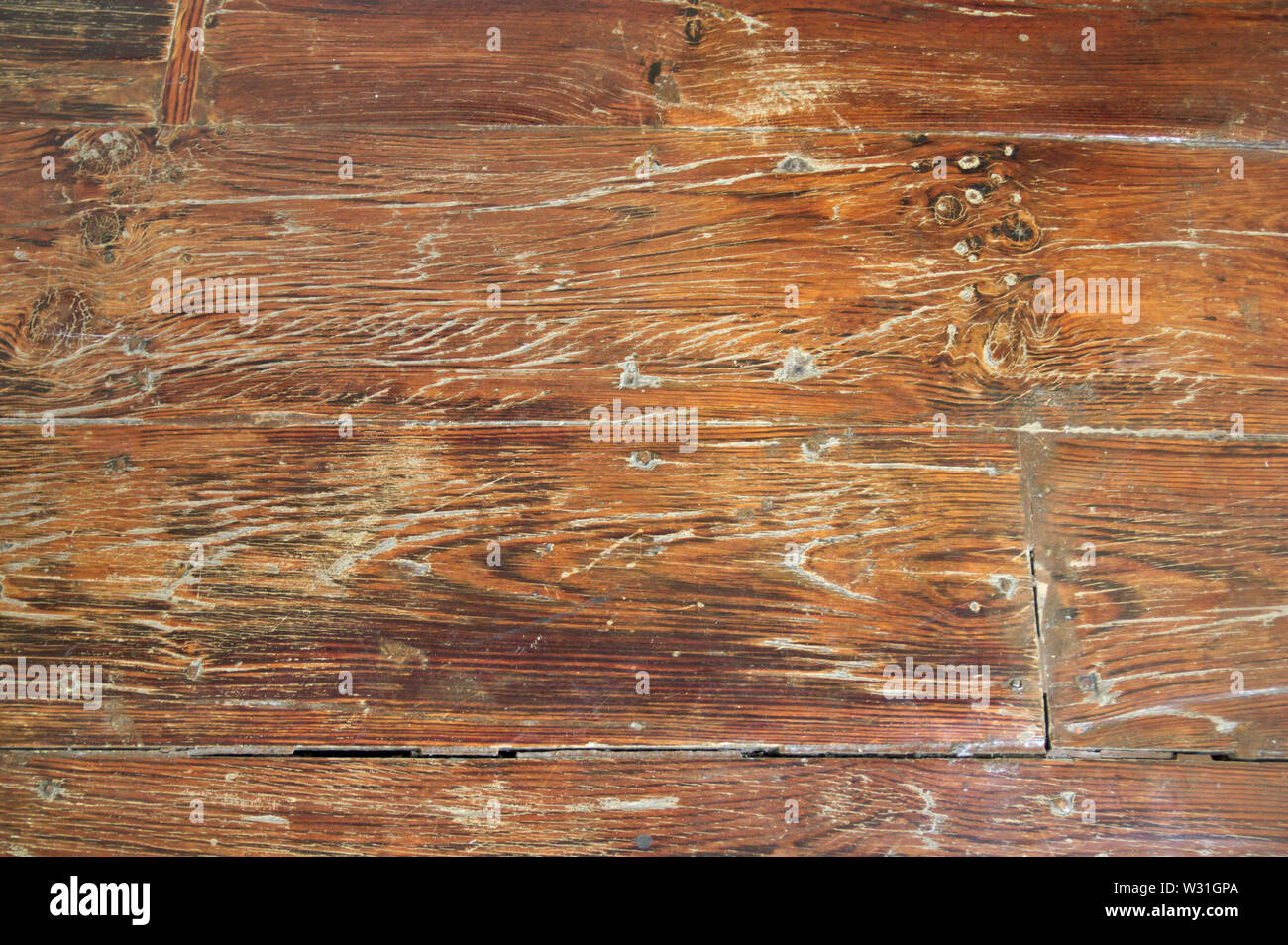 Close Up Of An Old And Used Wooden Floor With Cracks And With Some