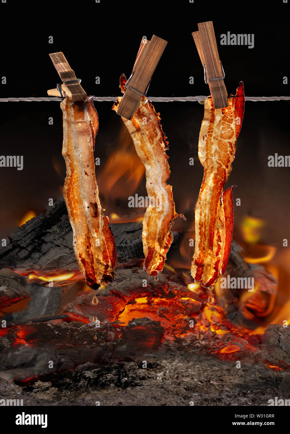 raosting and smopking on open fire with pork belly bacon spareribs and chicken legs Stock Photo