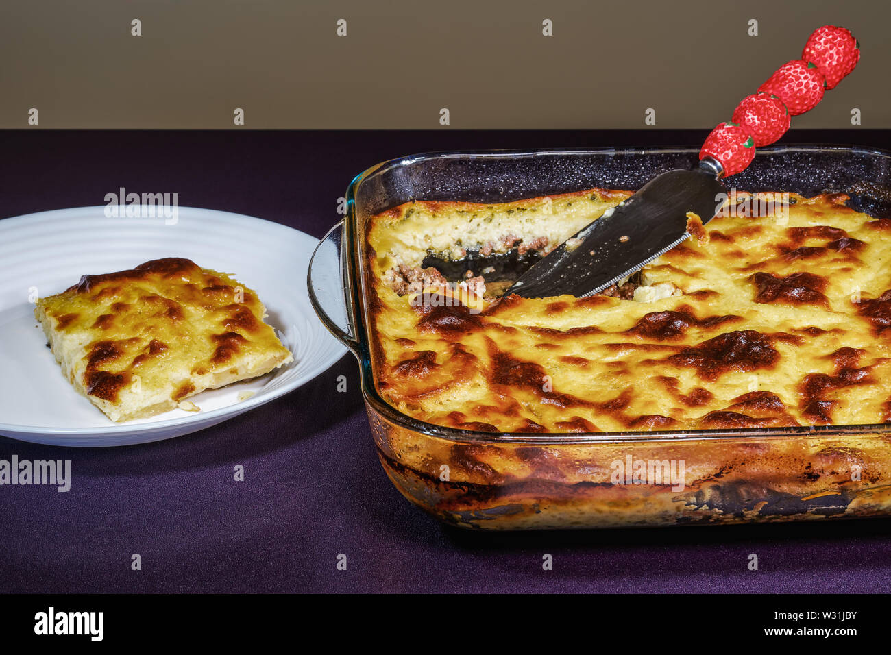 Greek moussaka dish recipe preparation. Ready meal with served portion