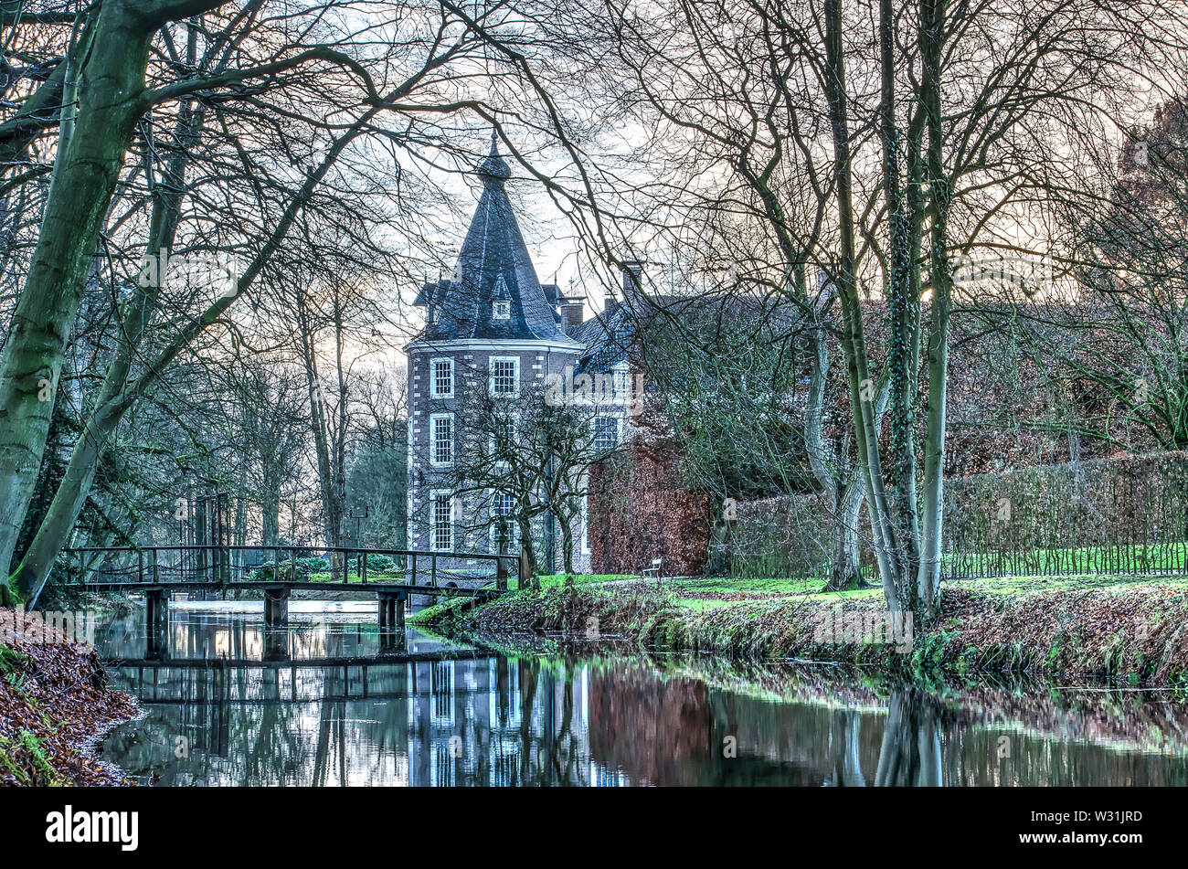 Heino, The Netherlands, December 12, 2017: part of Nijenhuis castle, nowadays in use as a museum, and the surrounding gardens and canals on a late aft Stock Photo