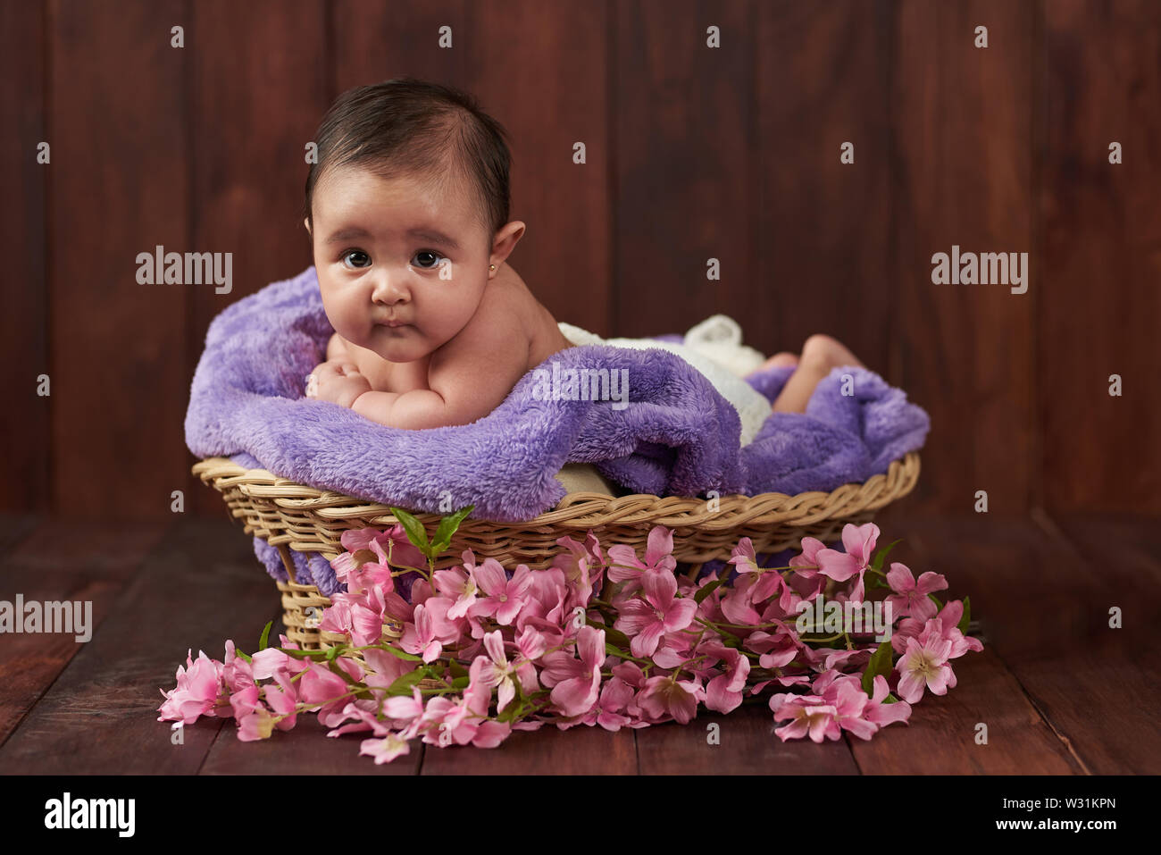 Portrait of adorable baby girl on wooden background Stock Photo