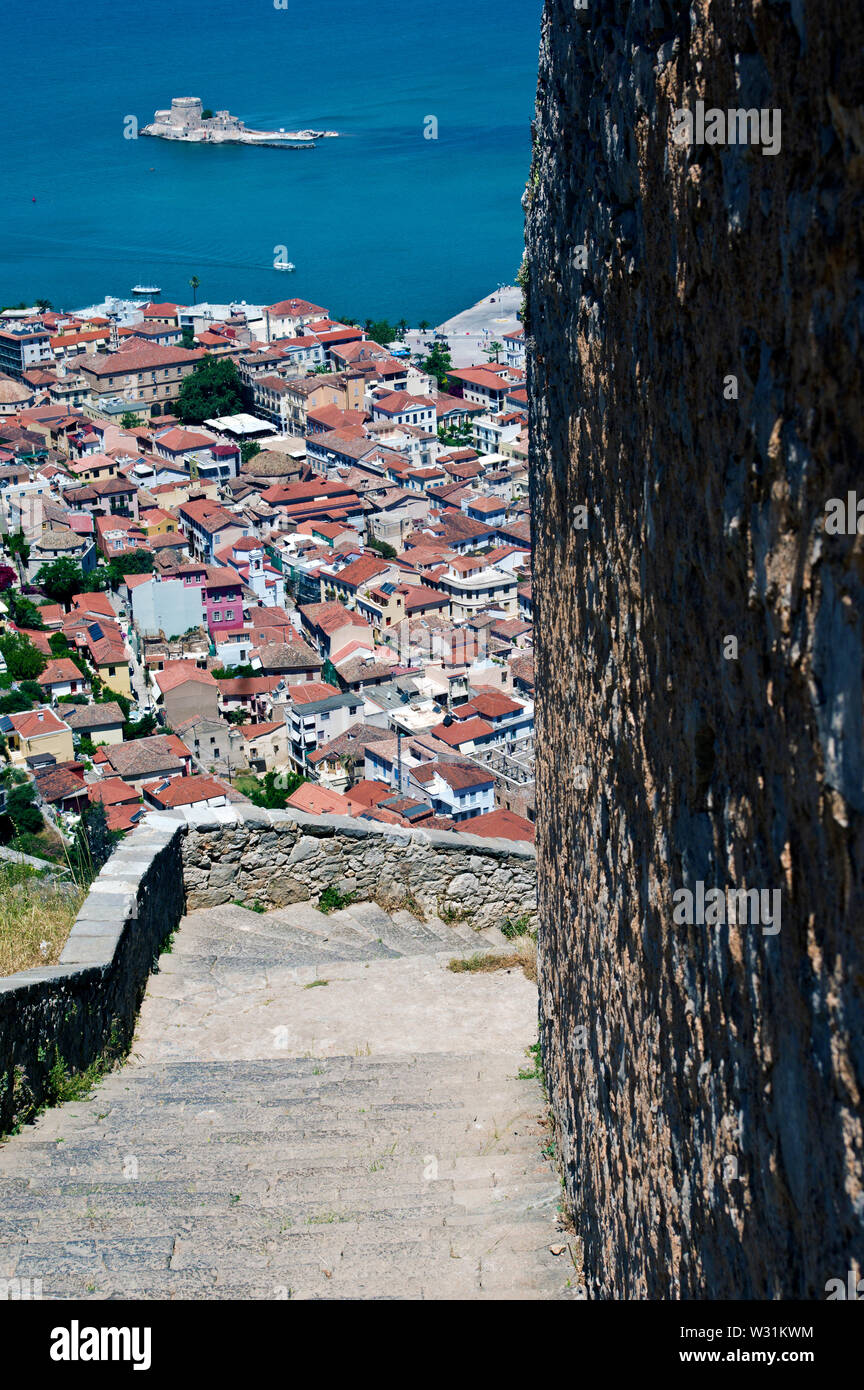 Looking at Naflio, Greece, from the steps of Palamidi Castle.  In the water in the background is the fortress of Bourtzi. Stock Photo