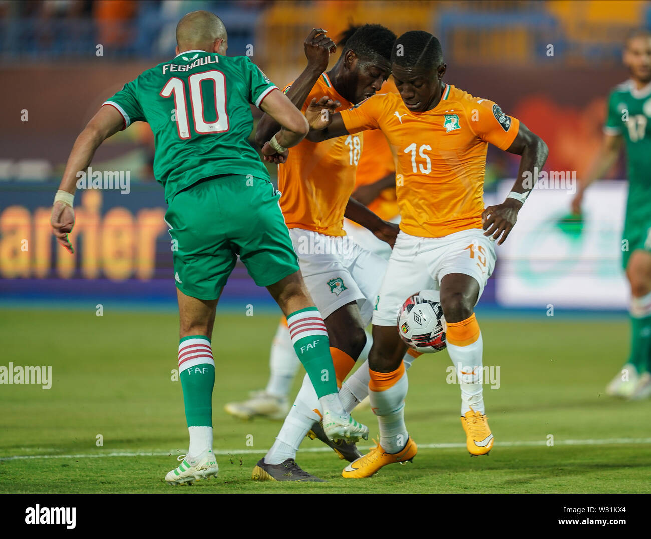 Suez, Egypt. 11th July, 2019. Ivory coast, Egypt - FRANCE OUT July 11, 2019: Max Alain Gradel of Cote D'ivoire trying to go past Sofiane Feghouli of Algeria during the 2019 African Cup of Nations match between Ivory coast and Algeria at the Suez Stadium in Suez, Egypt. Ulrik Pedersen/CSM/Alamy Live News Stock Photo