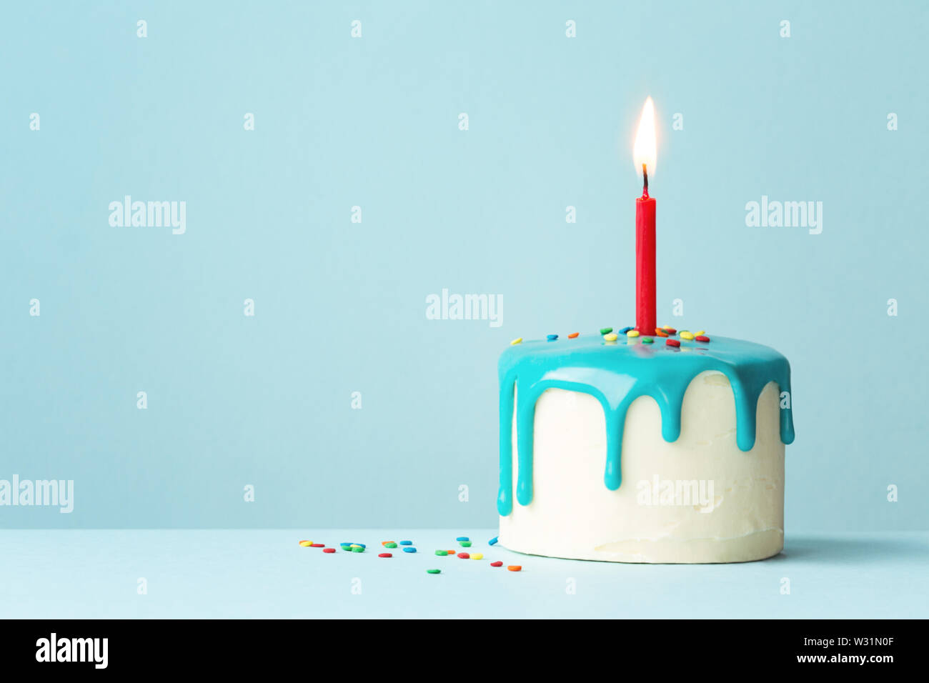 Birthday cake with drip frosting and one red candle Stock Photo