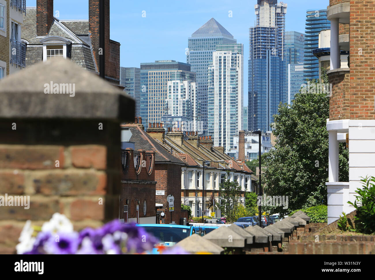 Houses on East Ferry Road with Canary Wharf beyond, on the Isle of Dogs