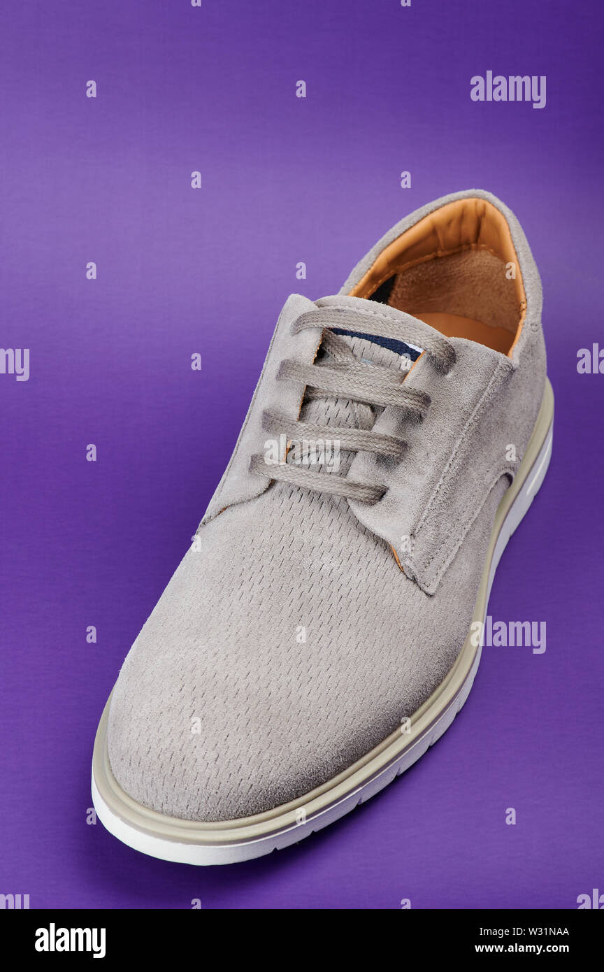 One men gray casual shoe isolated on purple background Stock Photo