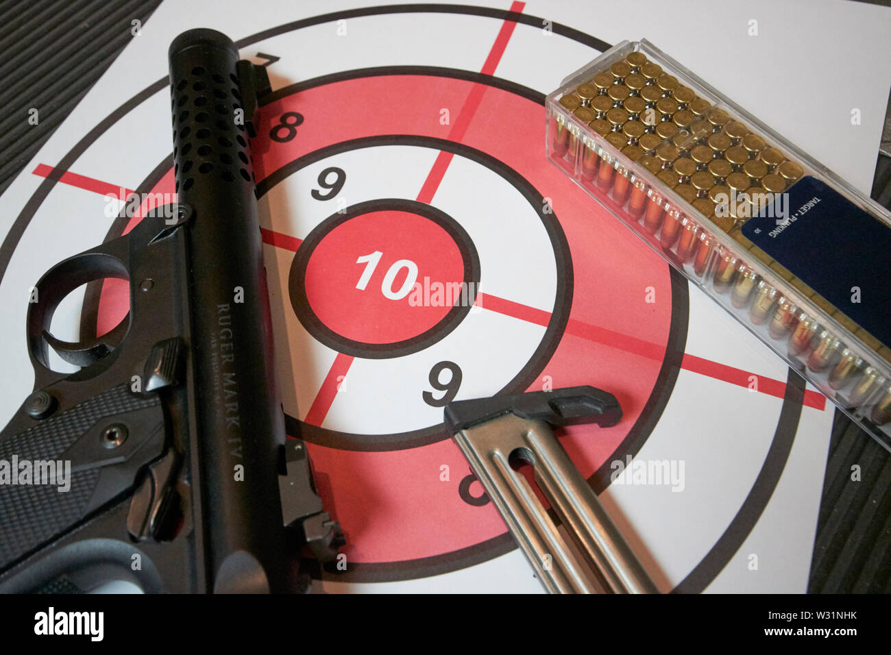 ruger mkiv .22 lr pistol with bullets magazine and target at a gun