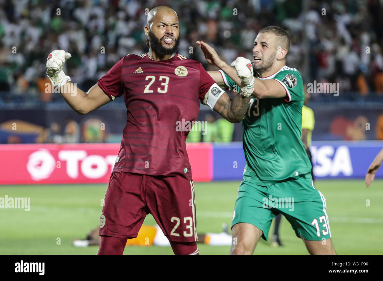 Suez, Egypt. 11th July, 2019. Algeria's Rais M'Bolhi (L) celebrates after the final whistle of the 2019 Africa Cup of Nations quarter final soccer match between Cote d'Ivoire and Algeria at the Suez Sports Stadium. Credit: Oliver Weiken/dpa/Alamy Live News Stock Photo