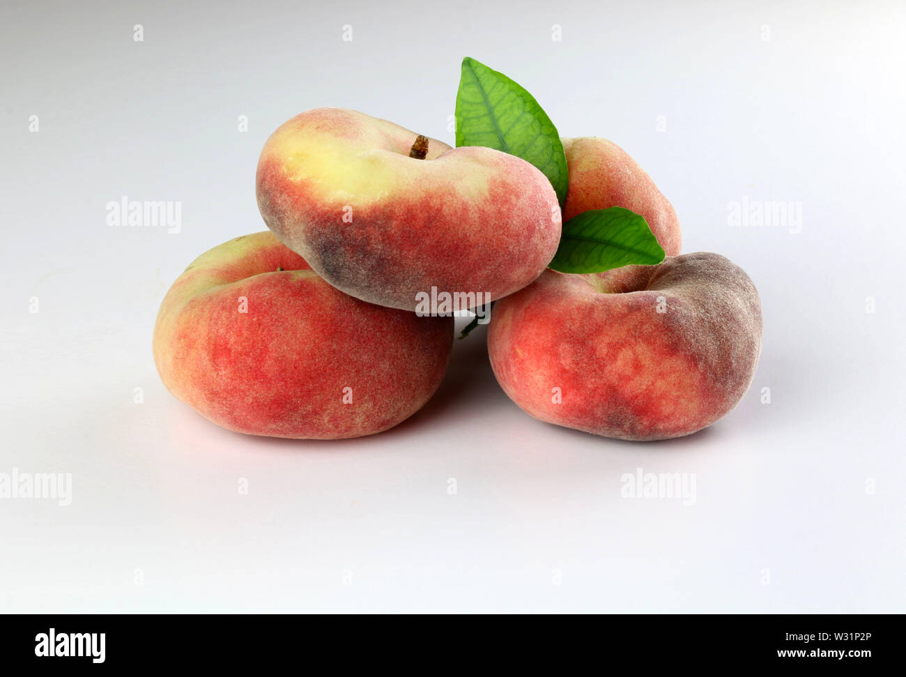 Snuff peaches on a white background Stock Photo