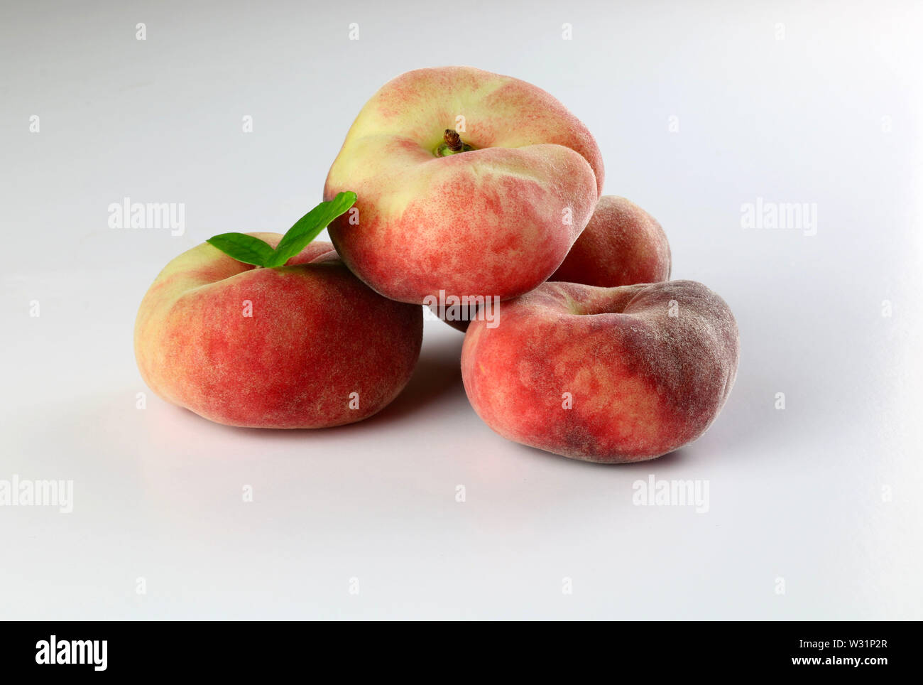 Snuff peaches on a white background Stock Photo