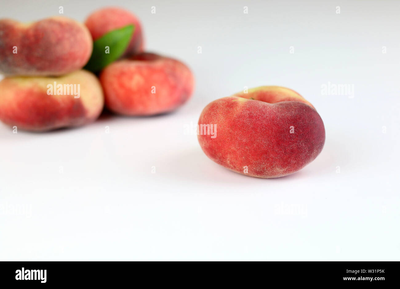 Snuff peaches on a white background Stock Photo