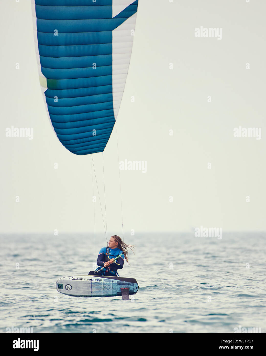 Armada Kiteboarding festival. Woman powering across the water on foils. Stock Photo