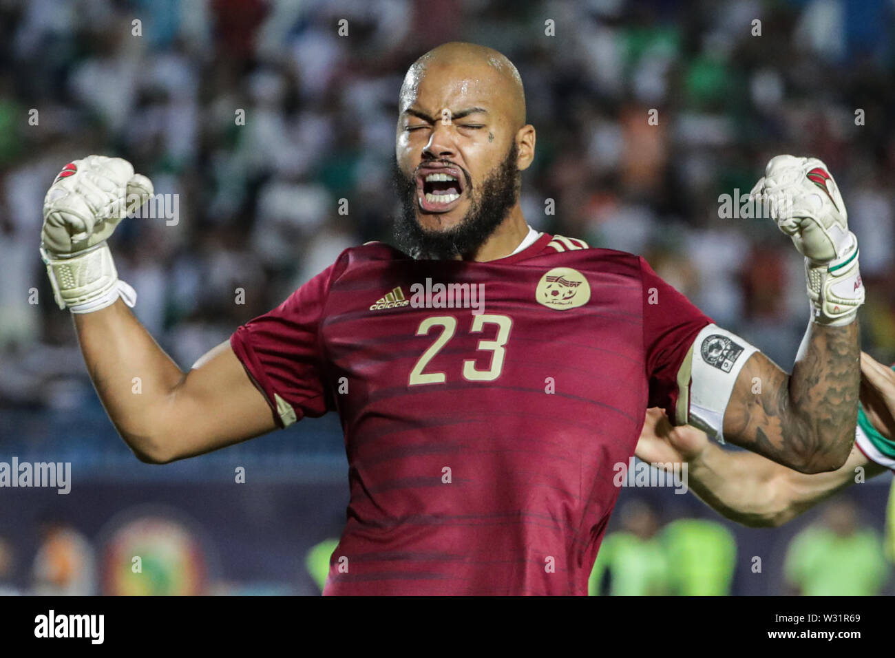 Suez, Egypt. 11th July, 2019. Algeria's Rais M'Bolhi celebrates after the final whistle of the 2019 Africa Cup of Nations quarter final soccer match between Cote d'Ivoire and Algeria at the Suez Sports Stadium. Credit: Oliver Weiken/dpa/Alamy Live News Stock Photo