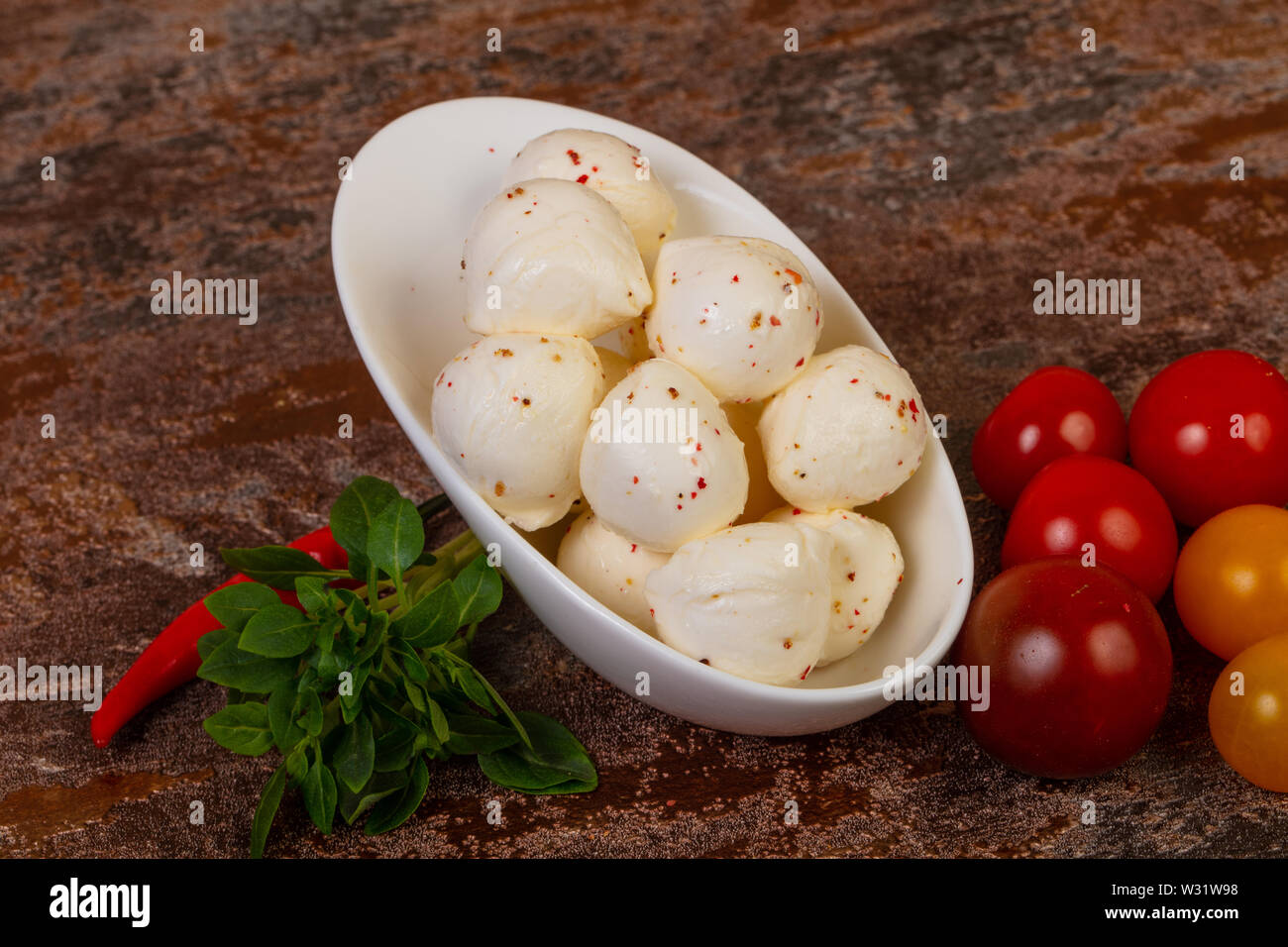 Mozzarella cheese balls with basil leaves and tomato Stock Photo - Alamy