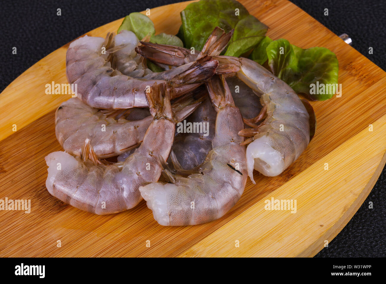 Raw king prawns ready for cooking served salad leaves Stock Photo Alamy