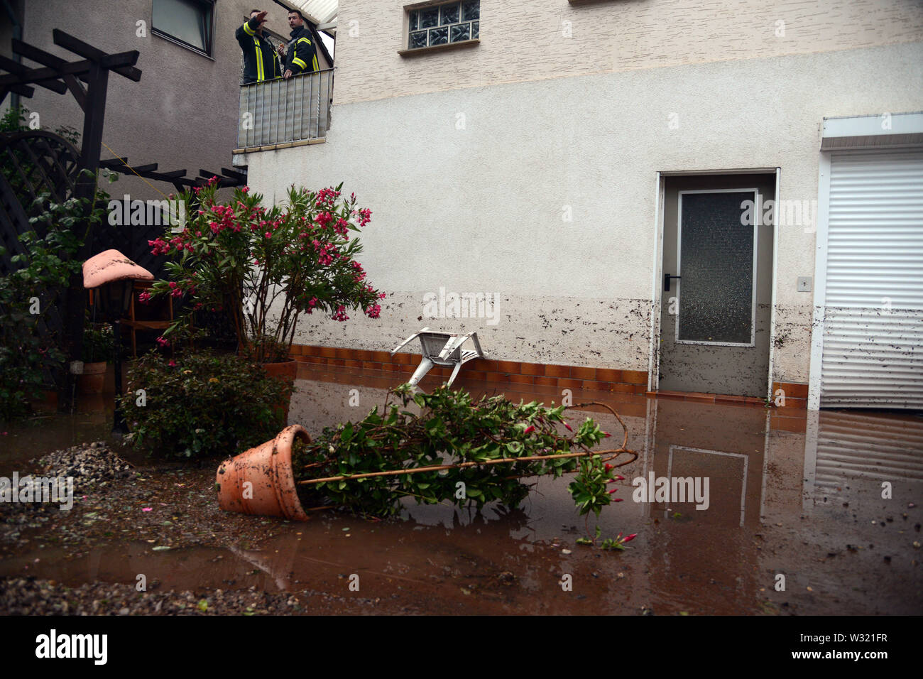 Trier, Germany. 11th July, 2019. Traces on the outer wall of a property in the Olewig district indicate the height of the flooding. A violent storm with heavy rain and hail had swept over the region and flooded numerous streets and cellars. Credit: Harald Tittel/dpa/Alamy Live News Stock Photo