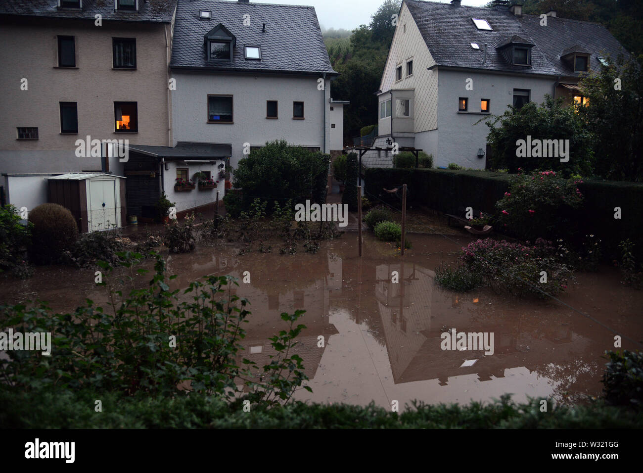 Trier, Germany. 11th July, 2019. Properties in the district of Olewig are flooded with water. A violent storm with heavy rain and hail swept over the region and flooded numerous streets and cellars. Credit: Harald Tittel/dpa/Alamy Live News Stock Photo