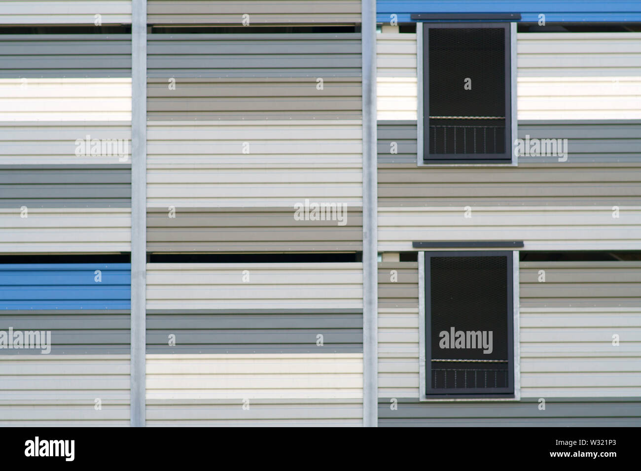 A modern industrial building with various sheet metal facades and grilles. Stock Photo