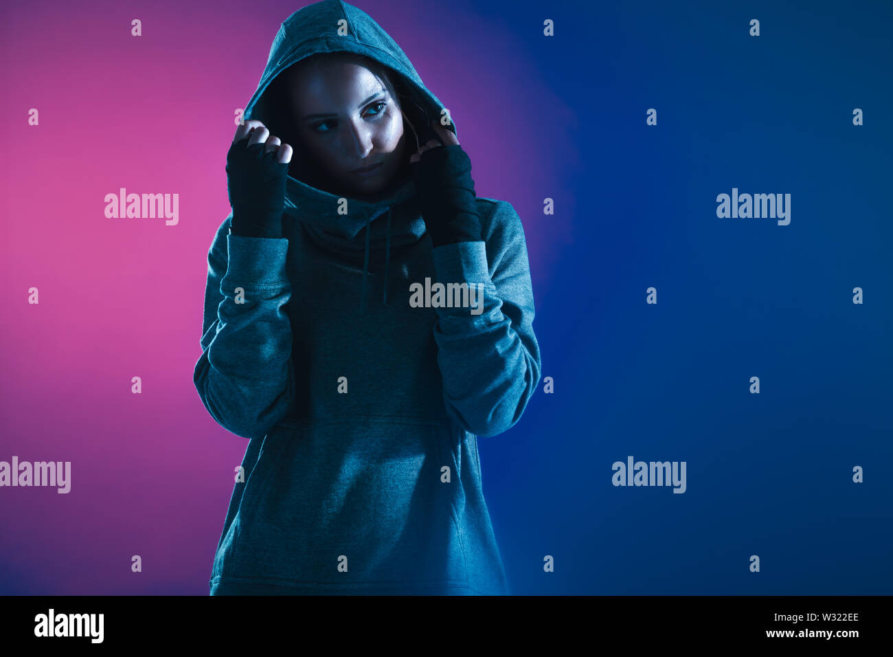 Woman wearing hoodie in gym Stock Photo - Alamy