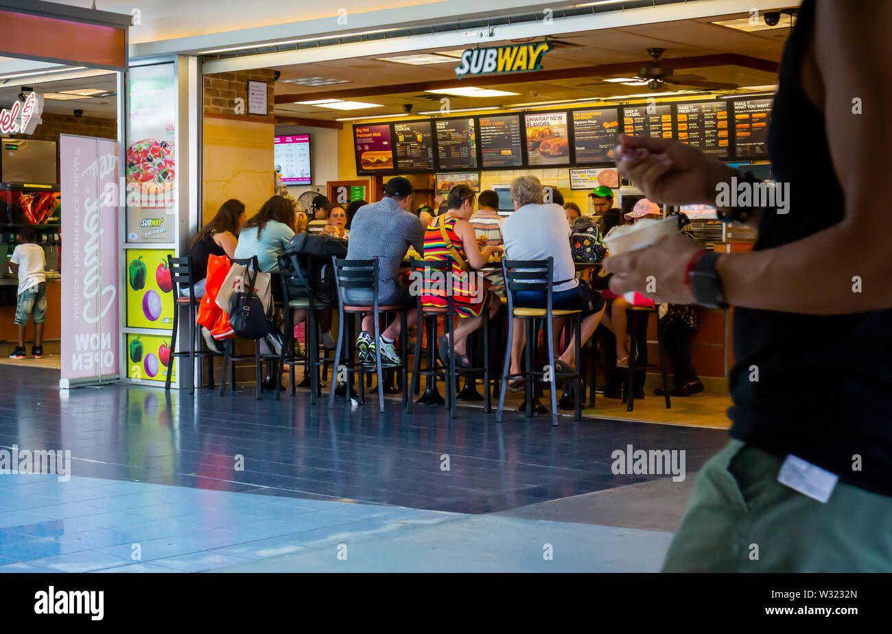 Diners crowd a franchise of the Subway sandwich chain in the Staten Island Ferry Terminal in New York on Saturday, July 6, 2019. (© Richard B. Levine) Stock Photo